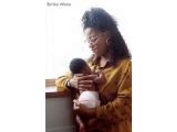African American Mother and Baby at Window