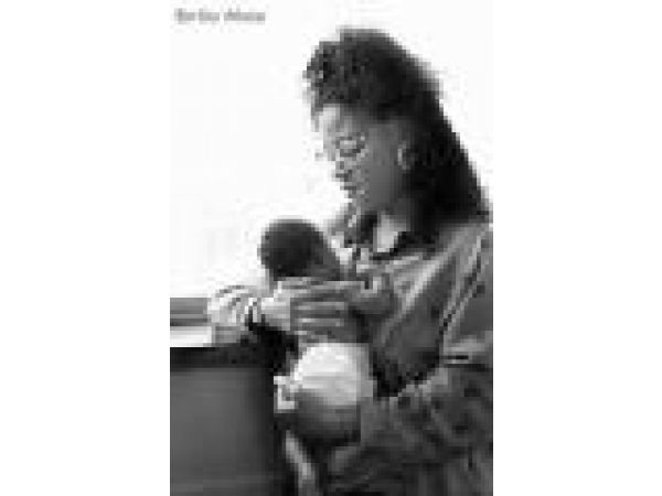 African American Mother Holding Baby by Window- Client: St. Mary's Medical Center